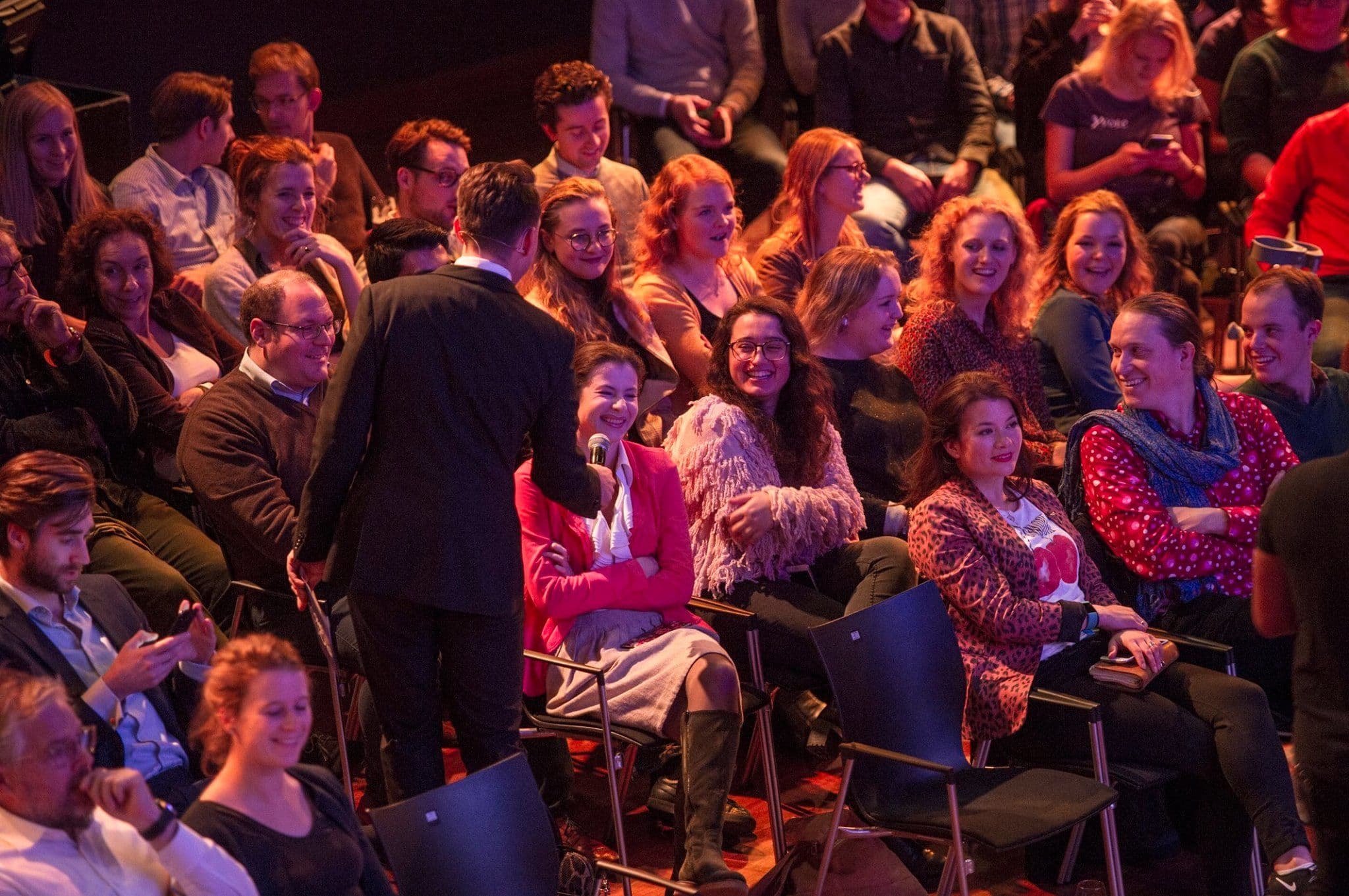 Facilitator with a microphone in a mixed stakeholder audience