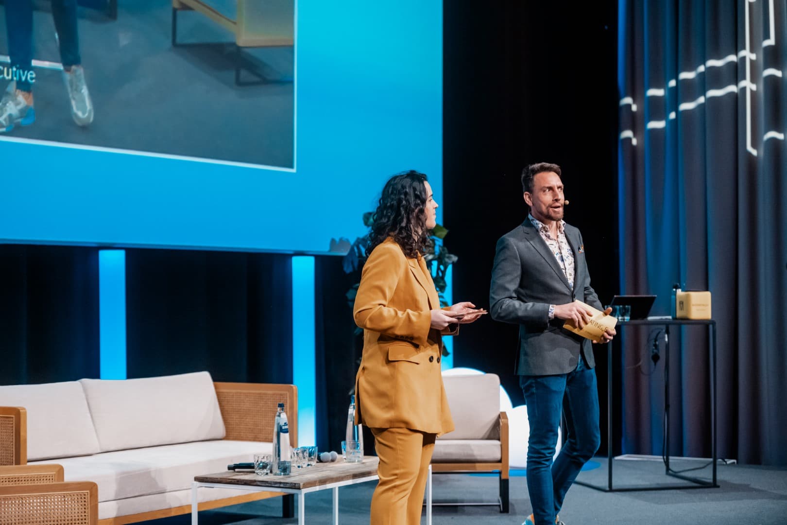 Professional moderators on stage at a European conference