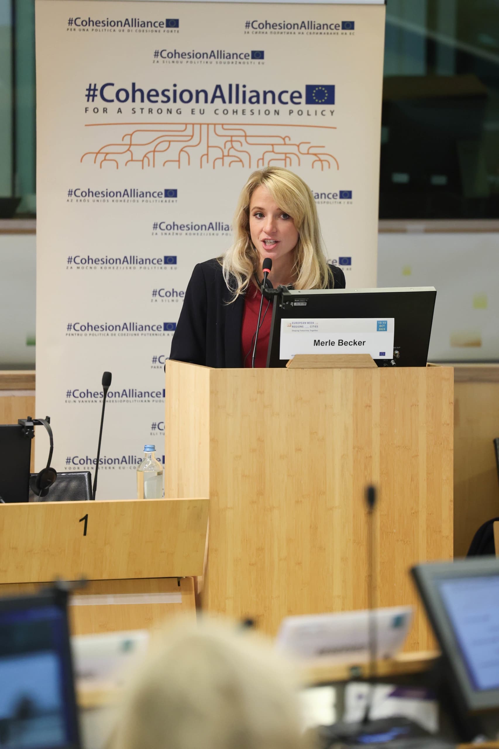 Two moderators hosting a European conference stage