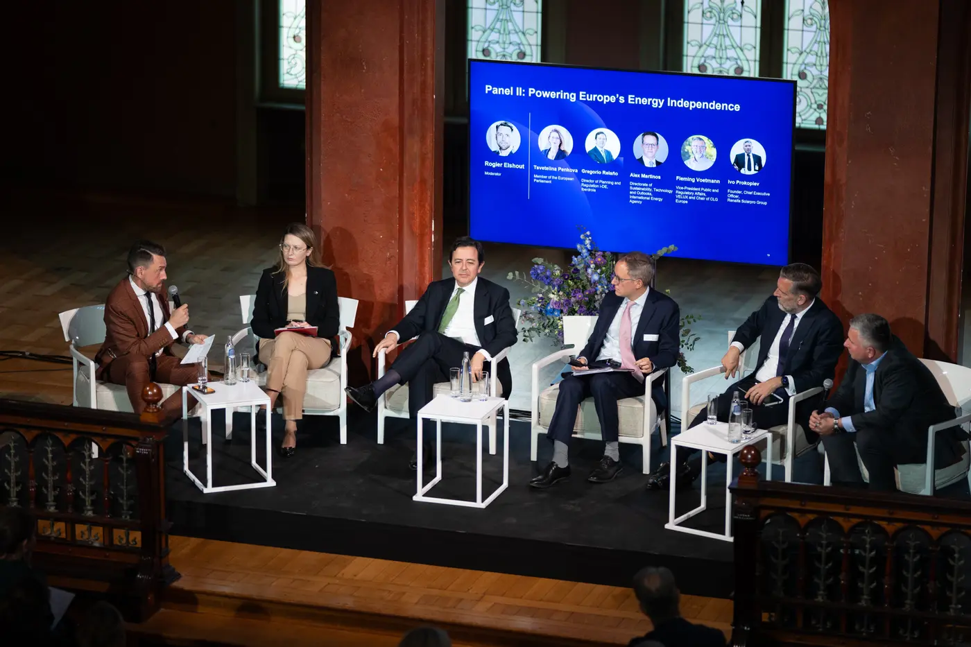 Moderator between speakers at a high-level European panel